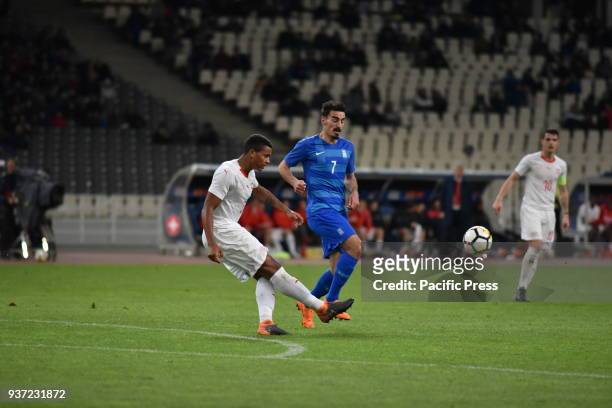 Manuel Akanji of Switzerland shots the ball way, in front of Lazaros Christodoulopoulos of Greece. Switzerland won against Greece with final score of...
