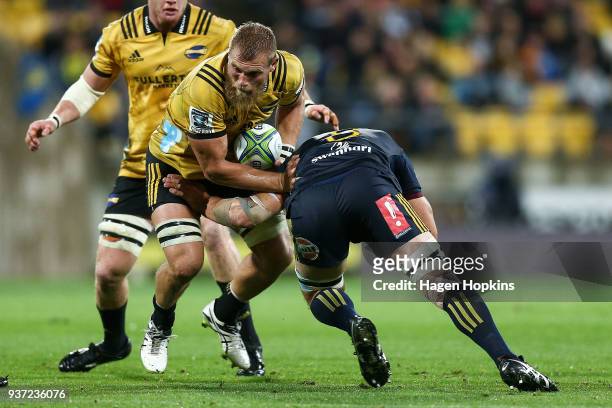 Brad Shields of the Hurricanes is tackled during the round six Super Rugby match between the Hurricanes and the Highlanders at Westpac Stadium on...