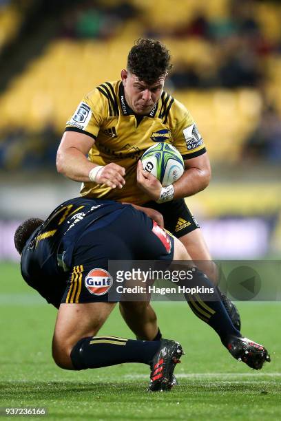 Ricky Riccitelli of the Hurricanes is tackled by Teihorangi Walden of the Highlanders during the round six Super Rugby match between the Hurricanes...