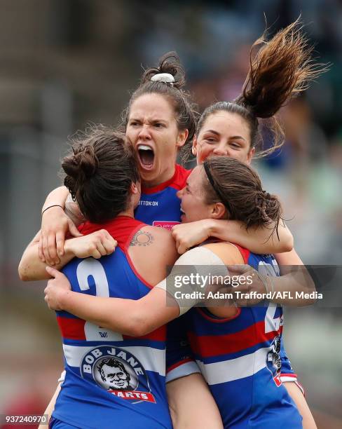 Emma Kearney of the Bulldogs celebrates a goal with teammates L-R Ellie Blackburn, Monique Conti and Kirsty Lamb during the 2018 AFLW Grand Final...