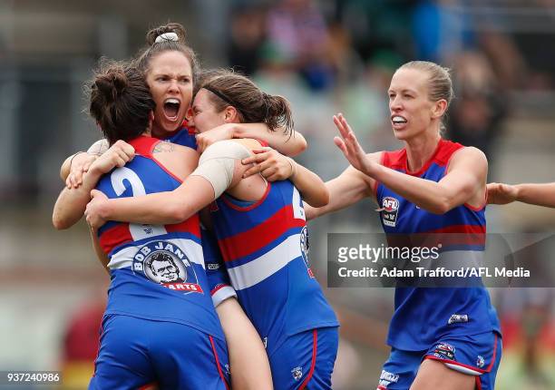 Emma Kearney of the Bulldogs celebrates a goal with teammates L-R Ellie Blackburn, Kirsty Lamb and Lauren Spark during the 2018 AFLW Grand Final...