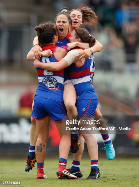 Emma Kearney of the Bulldogs celebrates a goal with teammates L-R Ellie Blackburn, Monique Conti and Kirsty Lamb during the 2018 AFLW Grand Final...