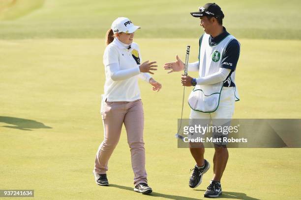 Himawari Ogura of Japan shakes hands with her caddie on the 18th green during the second round of the AXA Ladies Golf Tournament In Miyazaki at the...