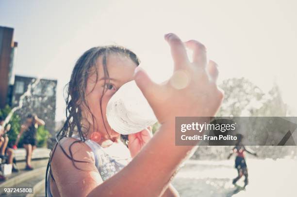 a girl drinking water. - 熱波 ストックフォトと画像