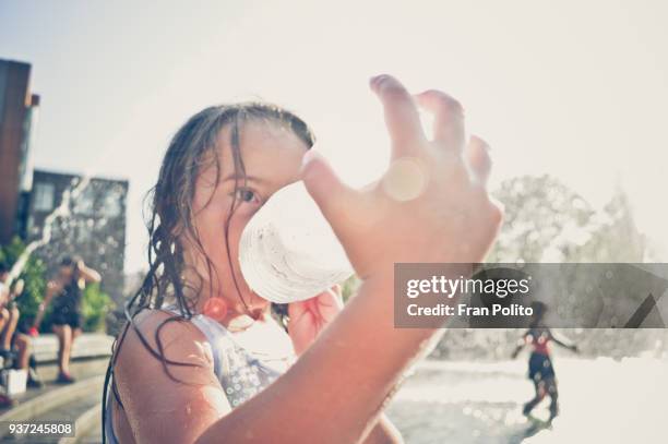 a girl drinking water. - fountain stock pictures, royalty-free photos & images