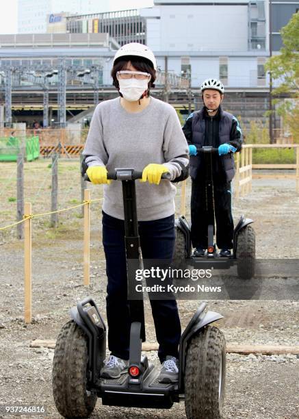 People ride Segways at Segway Base, an amusement park featuring a large area dedicated to the two-wheeled, self-balancing scooters, in Ebina, west of...