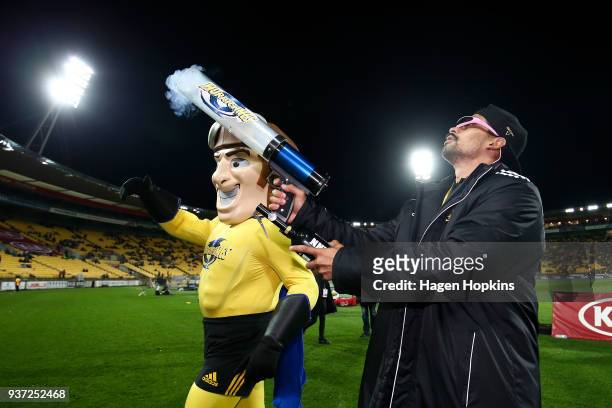 Celebrity Hurricane William Waiirua and Team mascot Captain Hurricane of the Hurricanes shoot a tshirt canon during the round six Super Rugby match...