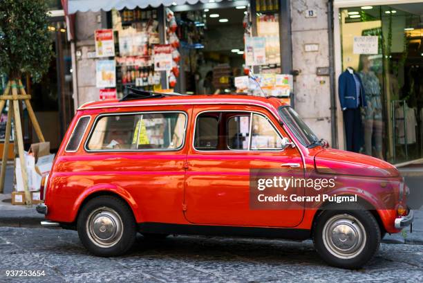 old red italian car parked on a street - gerard puigmal stock pictures, royalty-free photos & images