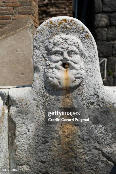 ruins of herculaneum (ercolano)a carved fountain head face at the ruins of herculaneum (ercolano) - gerard puigmal stock pictures, royalty-free photos & images