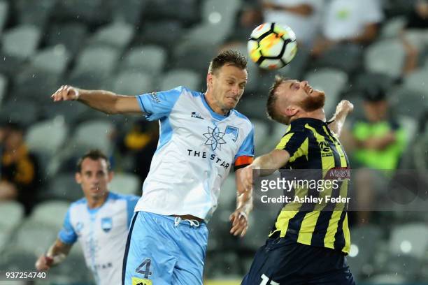 Connor Pain of the Mariners contests the header against Alexander Wilkinson of Sydney FC during the round 24 A-League match between the Central Coast...