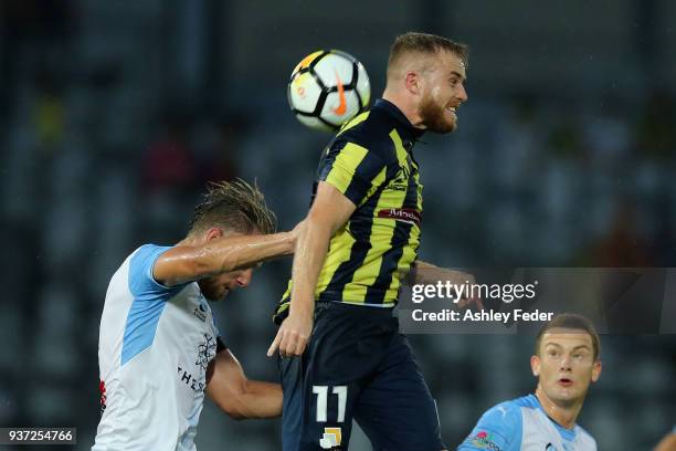 Connor Pain of the Mariners contests the header against Alexander Wilkinson of Sydney FC during the round 24 A-League match between the Central Coast...