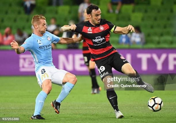 Oliver Bozanic of the City and Mark Bridge of the Wanderers compete for the ball during the round 24 A-League match between Melbourne City and the...