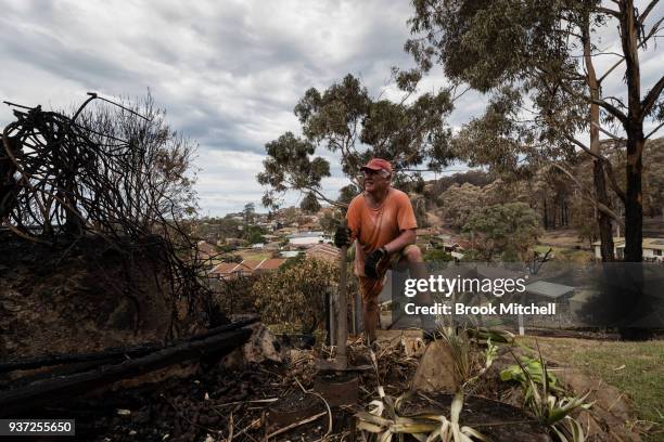 Richard Galton works to repair bushfire damage in the backayrd of his Tathra home on March 24, 2018 in Tathra, Australia. Ricard stayed to defend his...