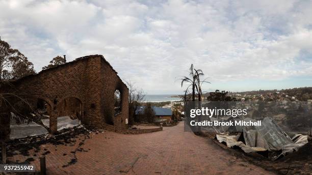 The burnt out remains of numerous houses is viewed from a hill overlooking the town of Tathra, Australia on on March 24, 2018. A bushfire which...