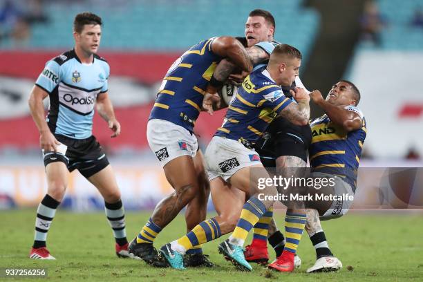 Josh Dugan of the Sharks is tackled during the round three NRL match between the Parramatta Eels and the Cronulla Sharks at ANZ Stadium on March 24,...