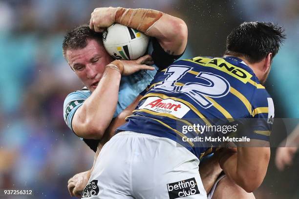 Paul Gallen of the Sharks is tackled during the round three NRL match between the Parramatta Eels and the Cronulla Sharks at ANZ Stadium on March 24,...