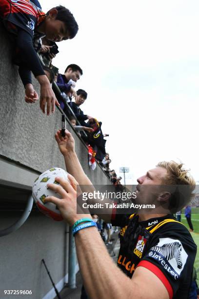 Damian McKenzie of the Chiefs signs autographs for fans after the Super Rugby match between Sunwolves and Chiefs at Prince Chichibu Memorial Groound...