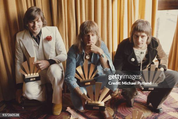 Rock musicians Greg Lake , Keith Emerson , and Carl Palmer, of the group Emerson Lake And Palmer receive their awards at the 1972 Melody Maker Pop...