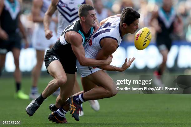 Darcy Byrne-Jones of the Power tackles Bailey Banfield of the Dockers during the 2018 AFL round 01 match between the Port Adelaide Power and the...