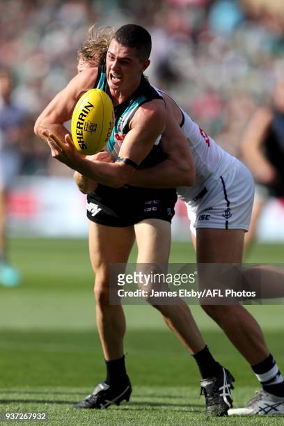 Darcy Byrne-Jones of the Power is tackled by David Mundy of the Dockers during the 2018 AFL round 01 match between the Port Adelaide Power and the...