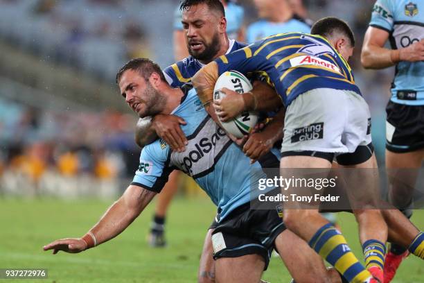 Luke Lewis of the Sharks is tackled during the round three NRL match between the Parramatta Eels and the Cronulla Sharks at ANZ Stadium on March 24,...