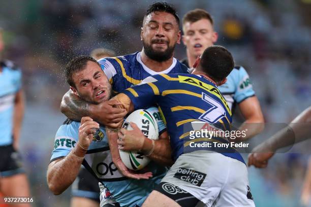Luke Lewis of the Sharks is tackled during the round three NRL match between the Parramatta Eels and the Cronulla Sharks at ANZ Stadium on March 24,...