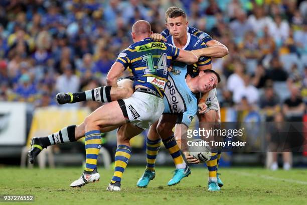 Paul Gallen of the Sharks is tackled during the round three NRL match between the Parramatta Eels and the Cronulla Sharks at ANZ Stadium on March 24,...