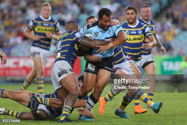 Joseph Paulo of the Sharks is tackled during the round three NRL match between the Parramatta Eels and the Cronulla Sharks at ANZ Stadium on March...