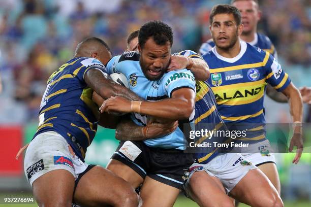 Joseph Paulo of the Sharks is tackled during the round three NRL match between the Parramatta Eels and the Cronulla Sharks at ANZ Stadium on March...