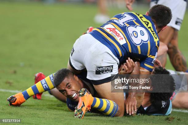 Michael Jennings of the Eels is tackled during the round three NRL match between the Parramatta Eels and the Cronulla Sharks at ANZ Stadium on March...