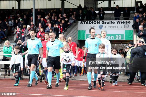 The teams enter the pitch prior to the UEFA Under19 European Championship Qualifier match between Germany and Norway at Stadion Grosse Wiese on March...