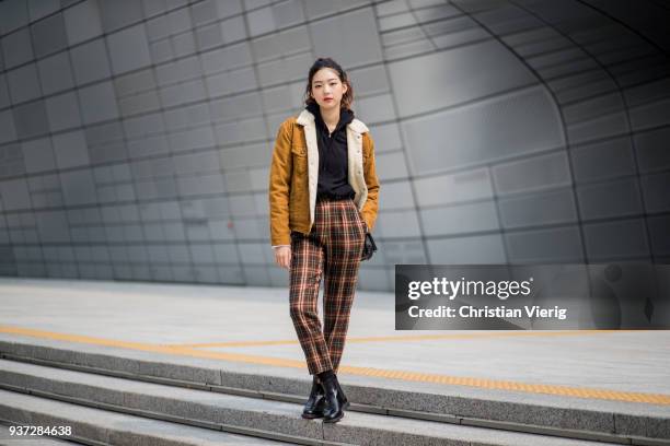 Model wearing mustard brown jacket, tartan pants is seen at the Hera Seoul Fashion Week 2018 F/W at Dongdaemun Design Plaza on March 24, 2018 in...