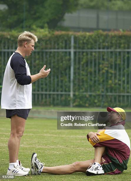 Shane Warne of Victoria talks to Matthew Hayden of the Queensland Bulls during today's training session, as the Bulls prepare to play Victoria in the...