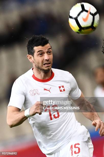 Switzerland's Berlim Dzemaili heads the ball during a friendly football match against Greece in Athens on March 23, 2018.