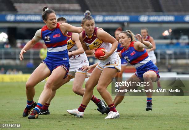 Megan Hunt of the Lions is tackled by Emma Kearney of the Bulldogs during the 2018 AFLW Grand Final match between the Western Bulldogs and the...