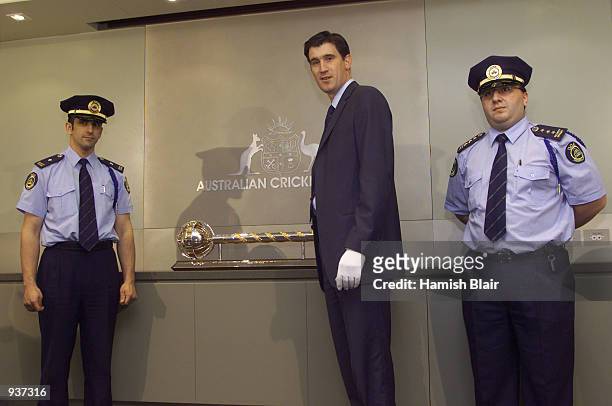 James Sutherland, chief executive of the ACB, receieves The ICC Test Championship Trophy from sercurity guards, at a press conference at the ACB...