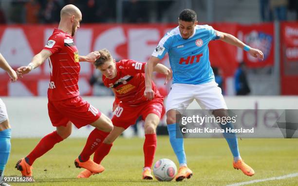 Daniel Brueckner and Bastian Kurz of Erfurt challenge Hamdi Dahmani of Koeln during the third Liga match between FC Rot Weiss Erfurt and SC Fortuna...