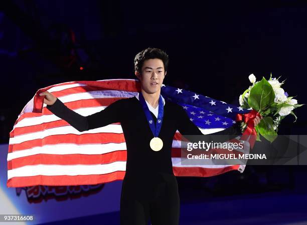 Gold medallist US Nathan Chen poses with a US flag on the podium of the Men-Free Skate program at the Milan World Figure Skating Championship 2018 on...