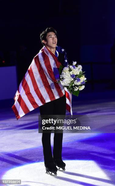 Gold medallist US Nathan Chen poses with a US flag on the podium of the Men-Free Skate program at the Milan World Figure Skating Championship 2018 on...