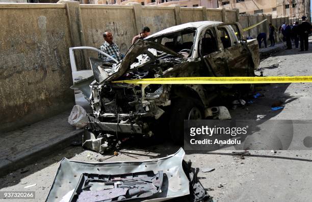 Damaged car is seen after an explosive placed under a car parked near police headquarters was set off, which killed a policeman and injured 4, in...