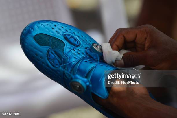 Cyclist prepares his cycling shoes just ahead of the start to the seventh stage, the 222.4 km from Nilai to Muar, of the 2018 Le Tour de Langkawi. On...