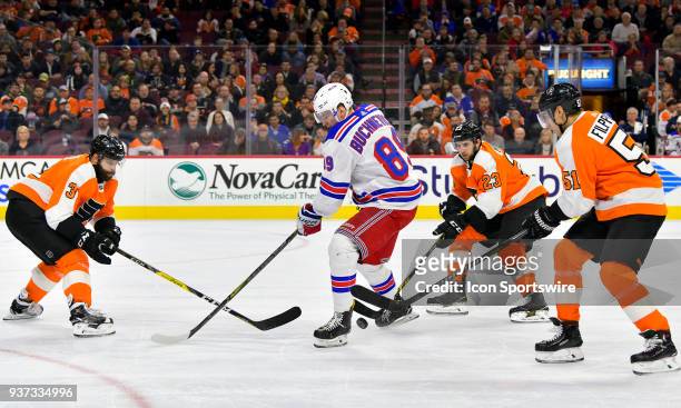 Philadelphia Flyers defenseman Brandon Manning picks the puck from New York Rangers right wing Pavel Buchnevich during the NHL game between the New...