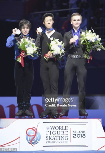 Nathan Chen of the United States poses with his gold medal after winning at the world figure skating championships in Milan, Italy, on March 24...
