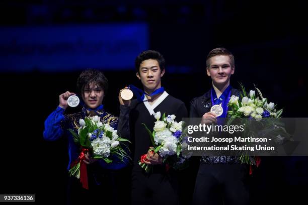 Shoma Uno of Japan, Nathan Chen of the United States and Mikhail Kolyada of Russia pose in the Men's medal ceremony during day four of the World...