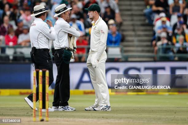 Australian fielder Cameron Bancroft is questioned by Umpires Richard Illingworth and Nigel Llong during the third day of the third Test cricket match...