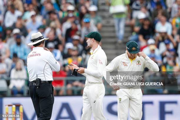 Australian fielder Cameron Bancroft is questioned by Umpires Richard Illingworth and Nigel Llong during the third day of the third Test cricket match...