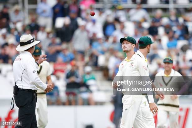 Australian fielder Cameron Bancroft throws the ball to Umpire Richard Illingworth during the third day of the third Test cricket match between South...