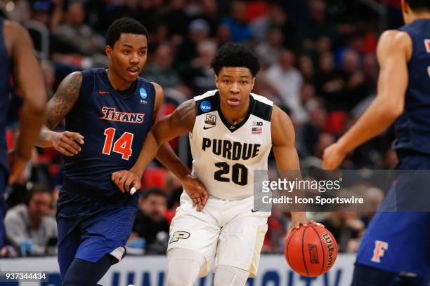 Purdue Boilermakers guard Nojel Eastern brings the ball up the court while being defended by Cal State Fullerton Titans guard Khalil Ahmad during the...