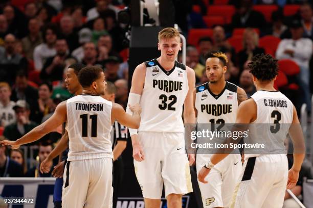 Purdue Boilermakers forward Matt Haarms , forward Vincent Edwards , guard P.J. Thompson , and guard Carsen Edwards huddle together after a play...