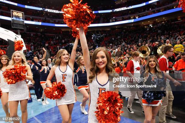 The Cal State Fullerton dance team waves to fans at the conclusion of the NCAA Division I Men's Championship First Round basketball game between the...